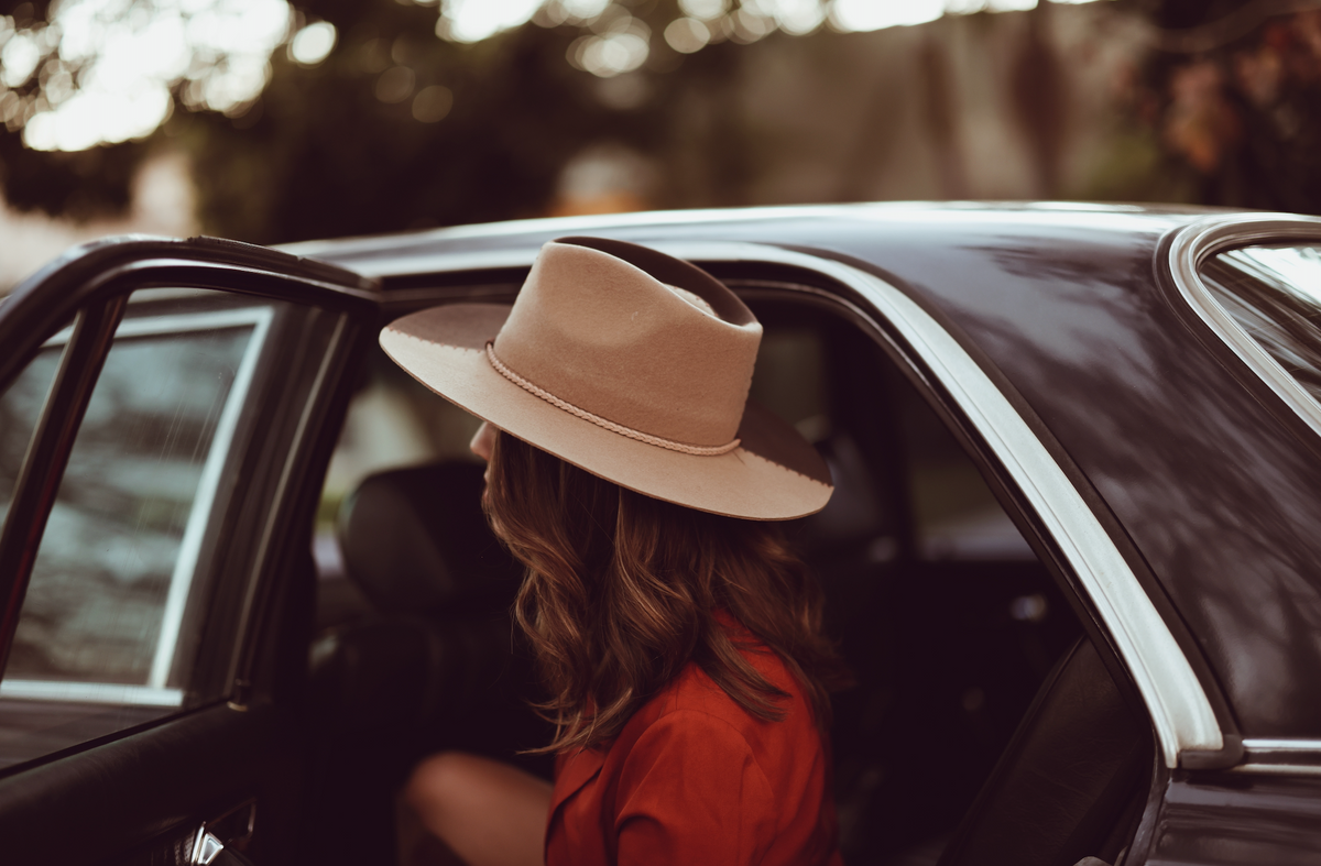 ASN Hats Cruel Intentions - Brown & Tan brown and tan fedora hat, worn inside a car with the brim in view