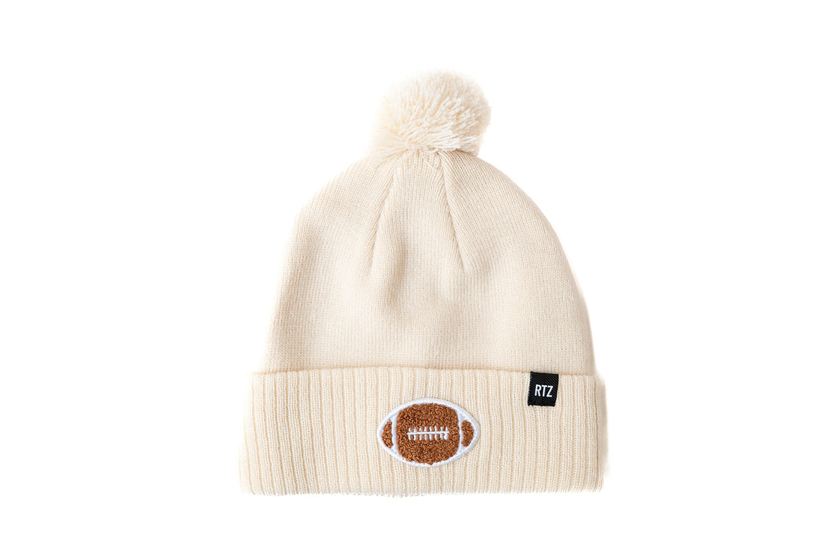 Rey To Z vanilla knit pom-pom hat with a football cuff patch