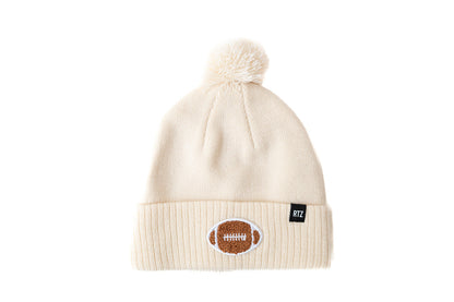 Rey To Z vanilla knit pom-pom hat with a football cuff patch