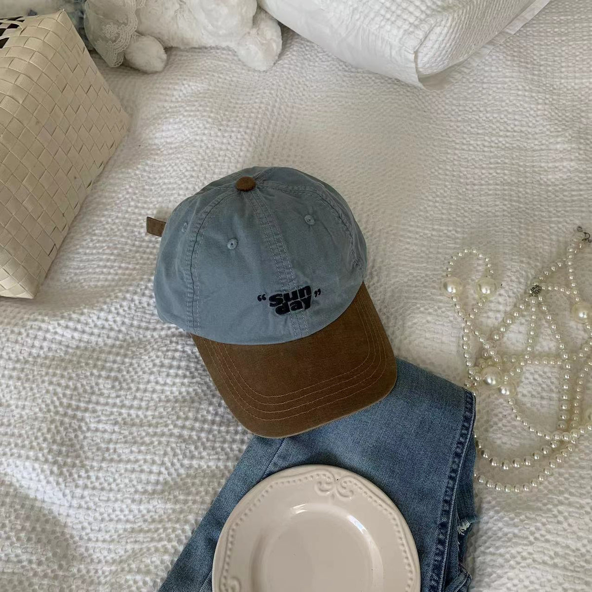 Blue cotton baseball cap showing its brown curved peak