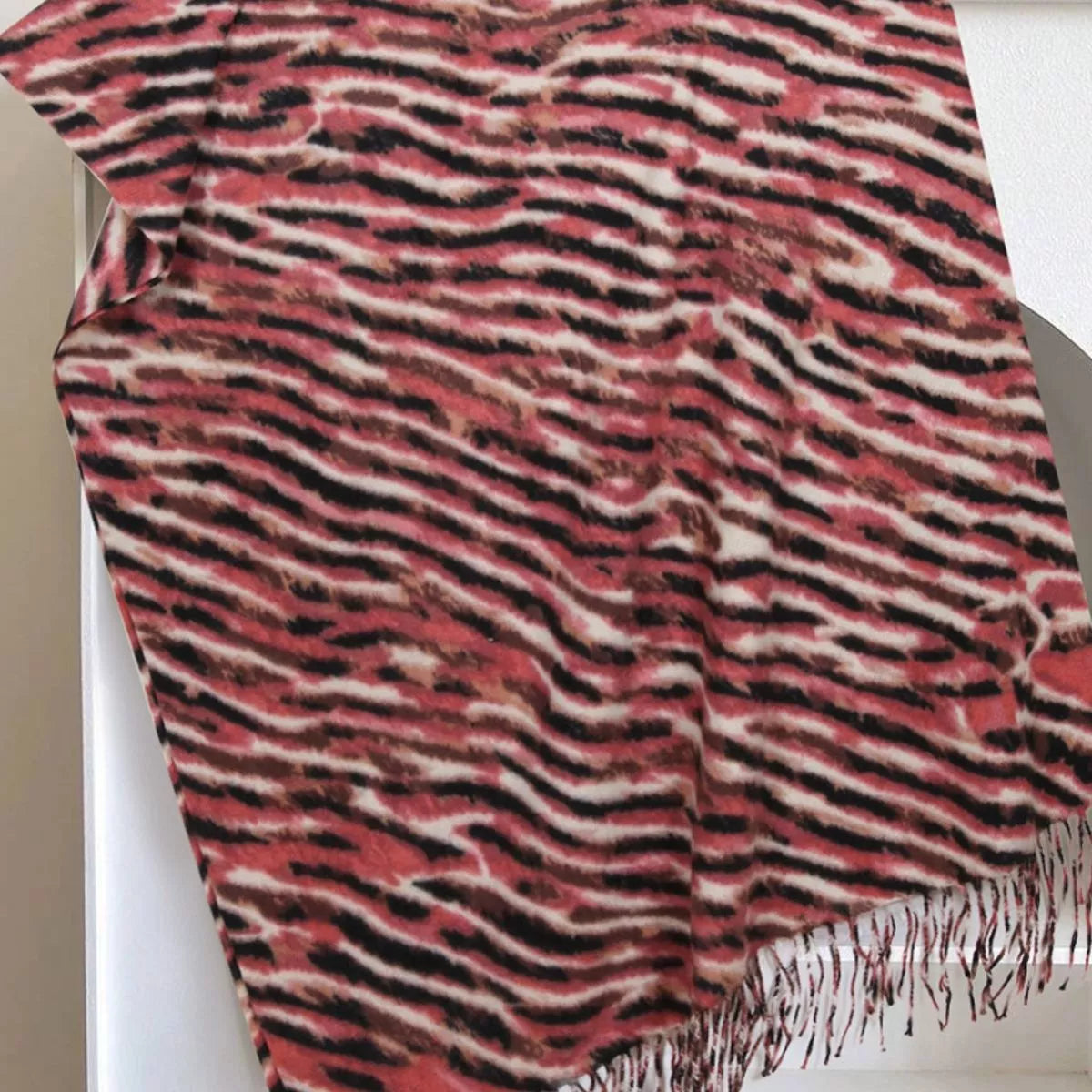 Unisex Fringe Printed Scarf — red scarf displayed with dark irregular marks and fringe