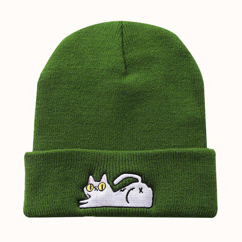 Green acrylic beanie with a reclining cat embroidered on the cuff