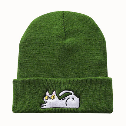 Green acrylic beanie with a reclining cat embroidered on the cuff