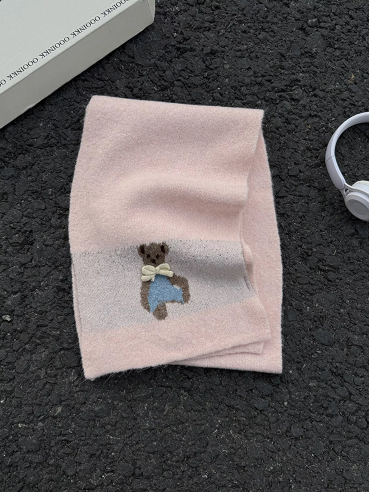 Unisex Bear Motif Knit Scarf — pink bear detail scarf folded on a dark surface