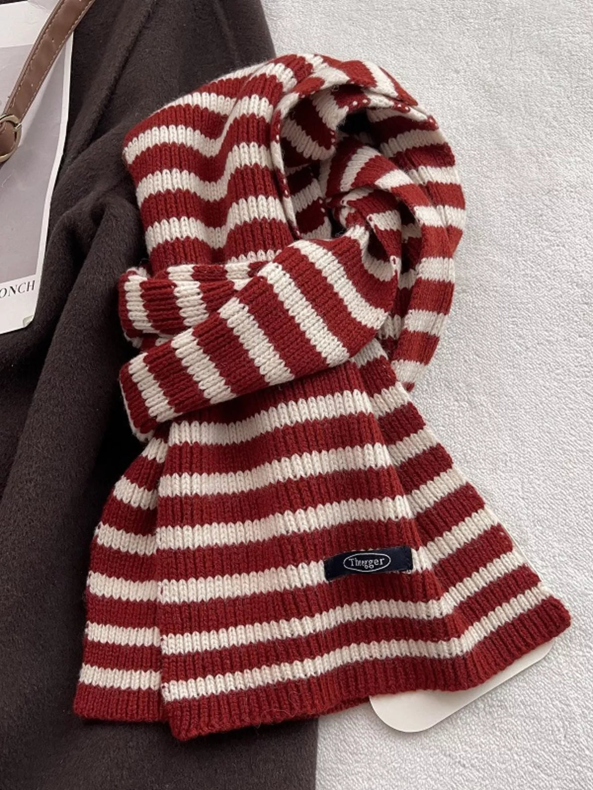 Unisex 100% Wool Striped Knitted Winter Scarf — red and cream striped scarf tied on a flat surface