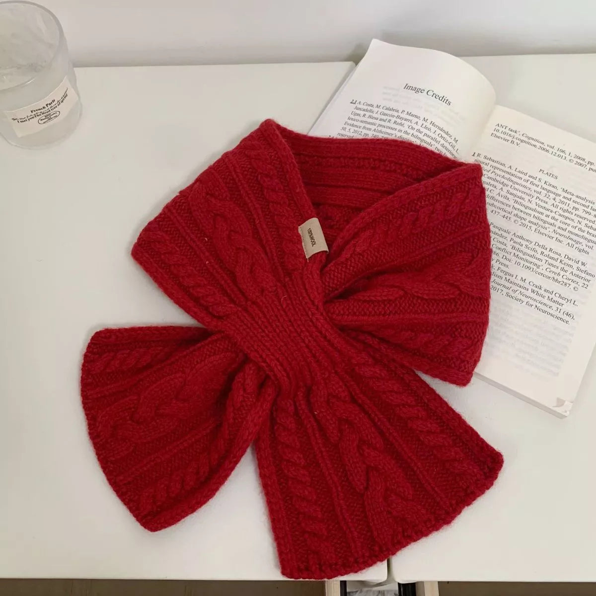 Unisex Cozy Cable Knit Scarf — short red cable scarf crossed in a bow-like arrangement