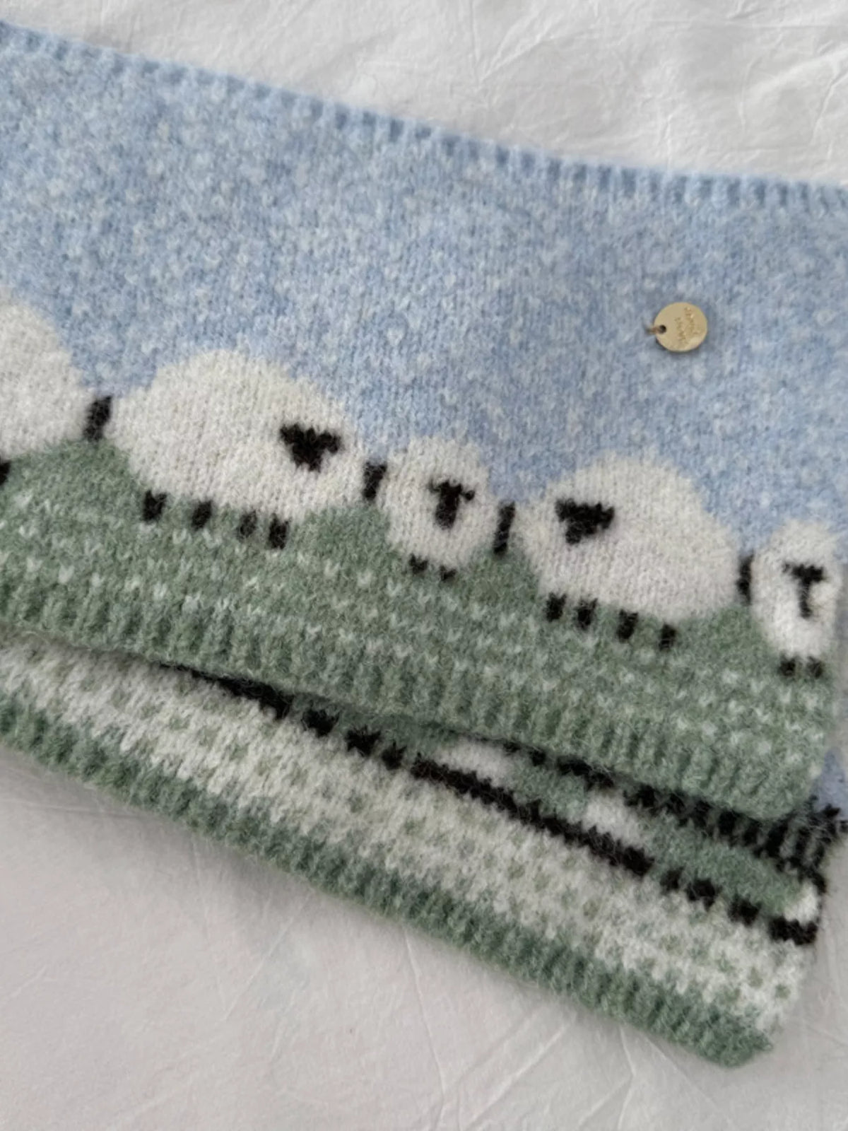 Unisex Sheep Motif Knit Scarf — close view of sheep motifs and striped end border