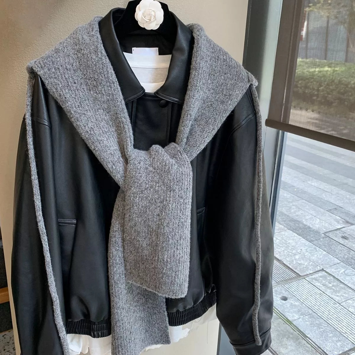Unisex Hooded Tie Knit Scarf — gray hooded scarf tied over a dark jacket