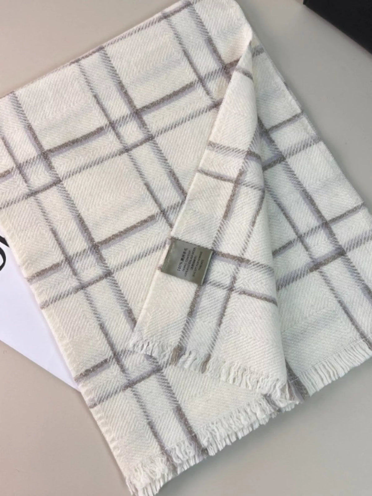 Unisex 100% Wool Raw Hem Plaid Scarf — folded ivory plaid scarf showing its edge finish