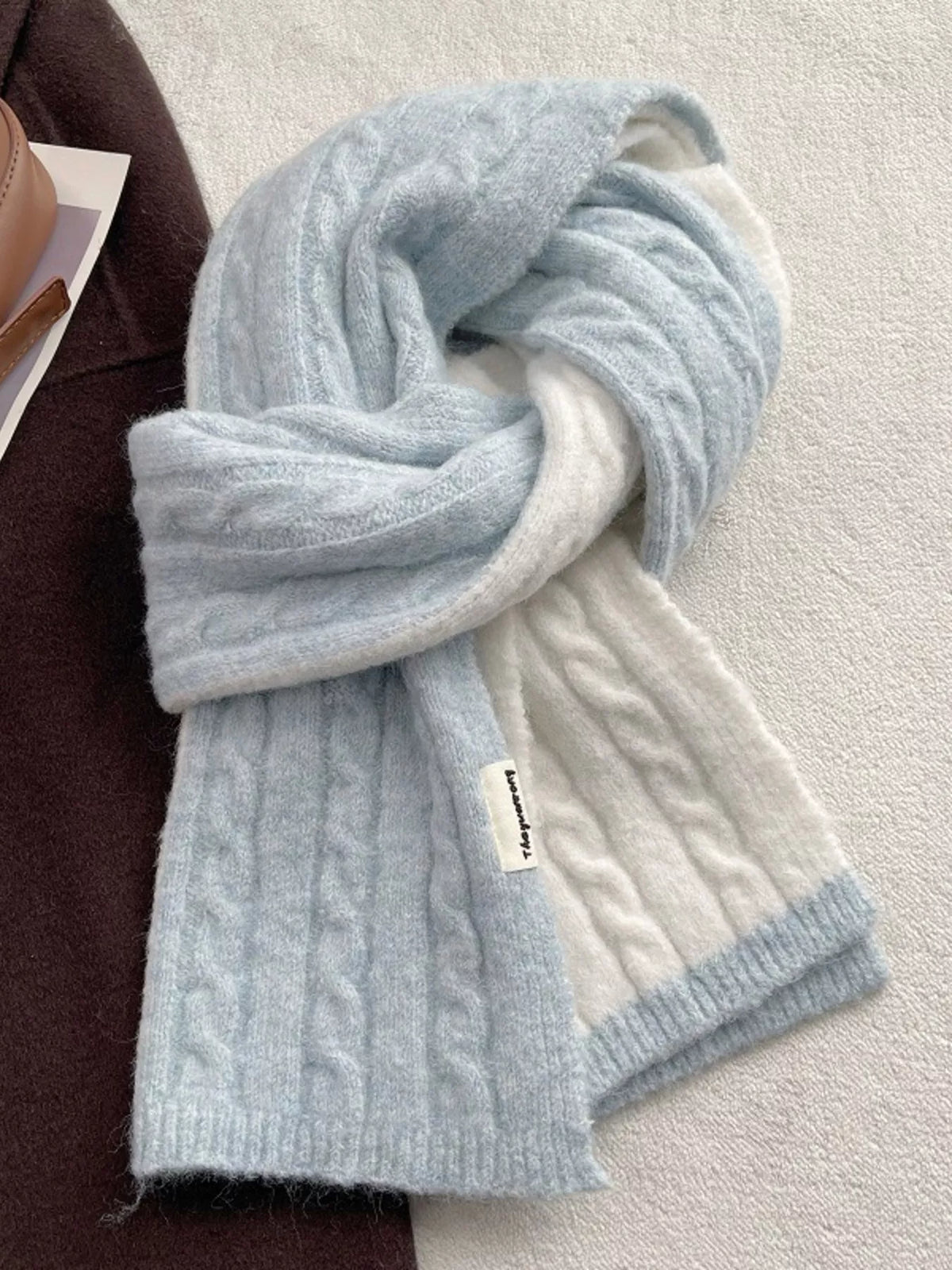 Unisex Two Tone Cable Knit Warm Scarf — pale blue and cream cable scarf tied on a flat surface