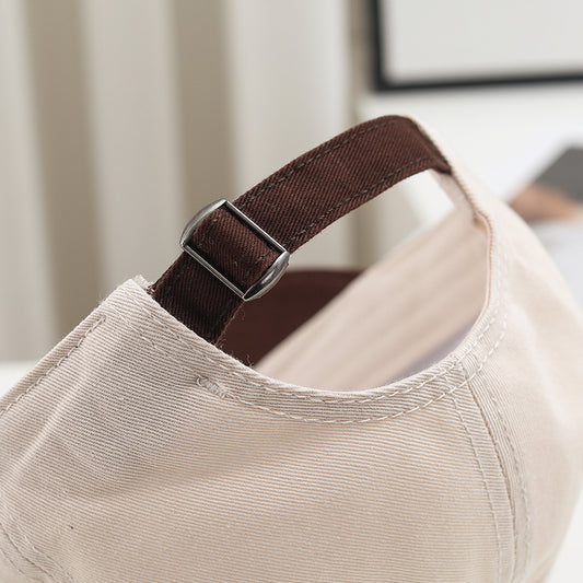 Close-up of the brown adjustable strap and metal buckle on Choo Choo cap