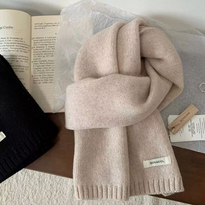 Unisex Warm Knitted Scarf — beige scarf looped on an open book