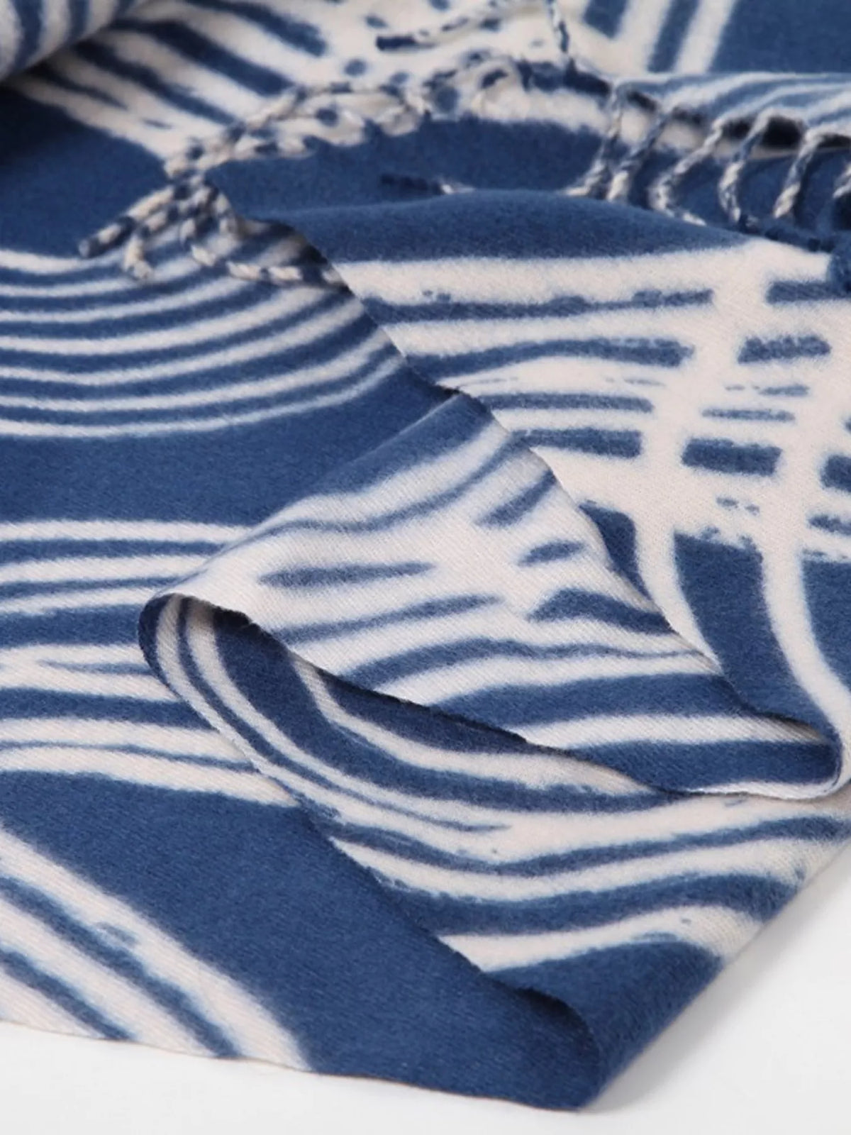 Unisex Geometric Patterned Fringe Scarf — close view of blue geometric fabric and folded edge