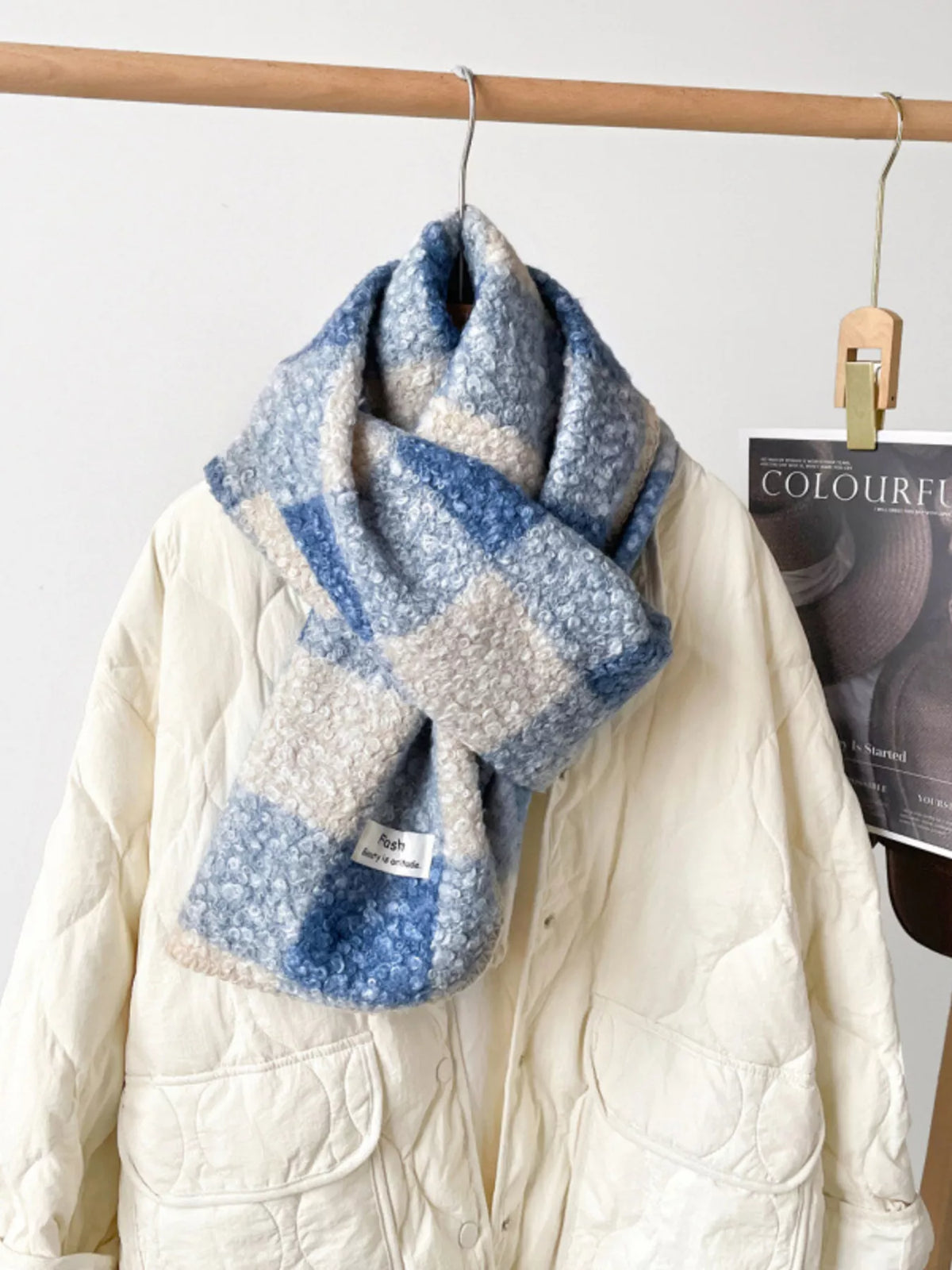 Unisex Textured Plaid Knit Scarf — light blue and cream plaid scarf looped over a pale sweater