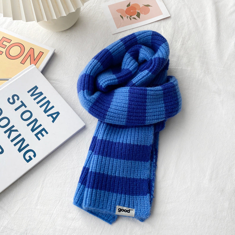 Blue tonal striped knit scarf tied in a loose loop