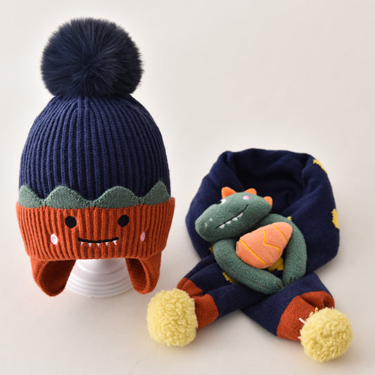 Navy and orange pom pom beanie with matching dinosaur scarf