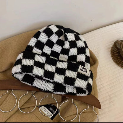 Black and white checked knit beanie with a front label