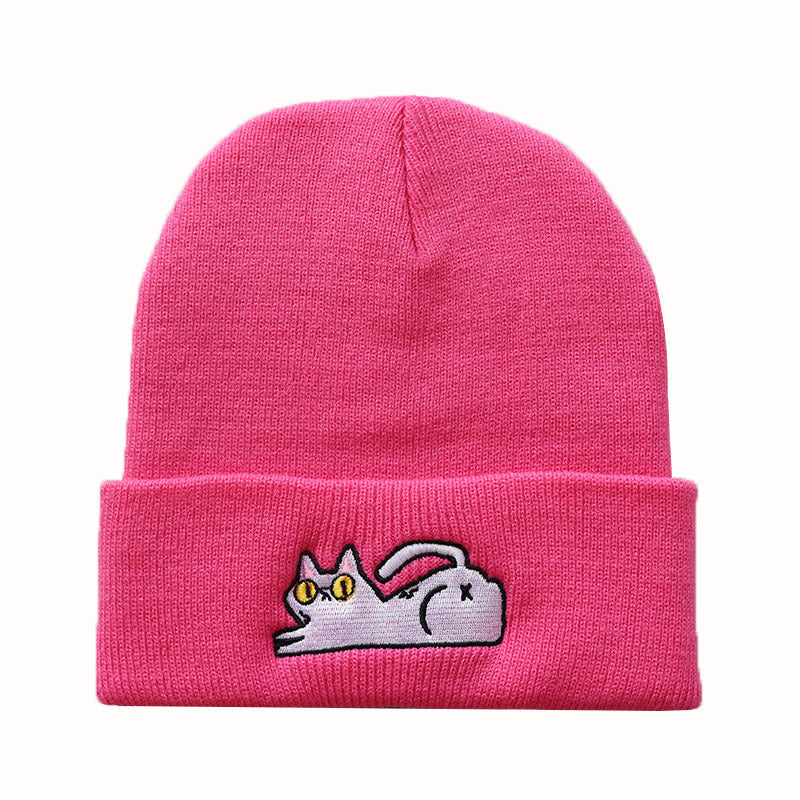 Bright pink cuffed beanie with reclining cat embroidery