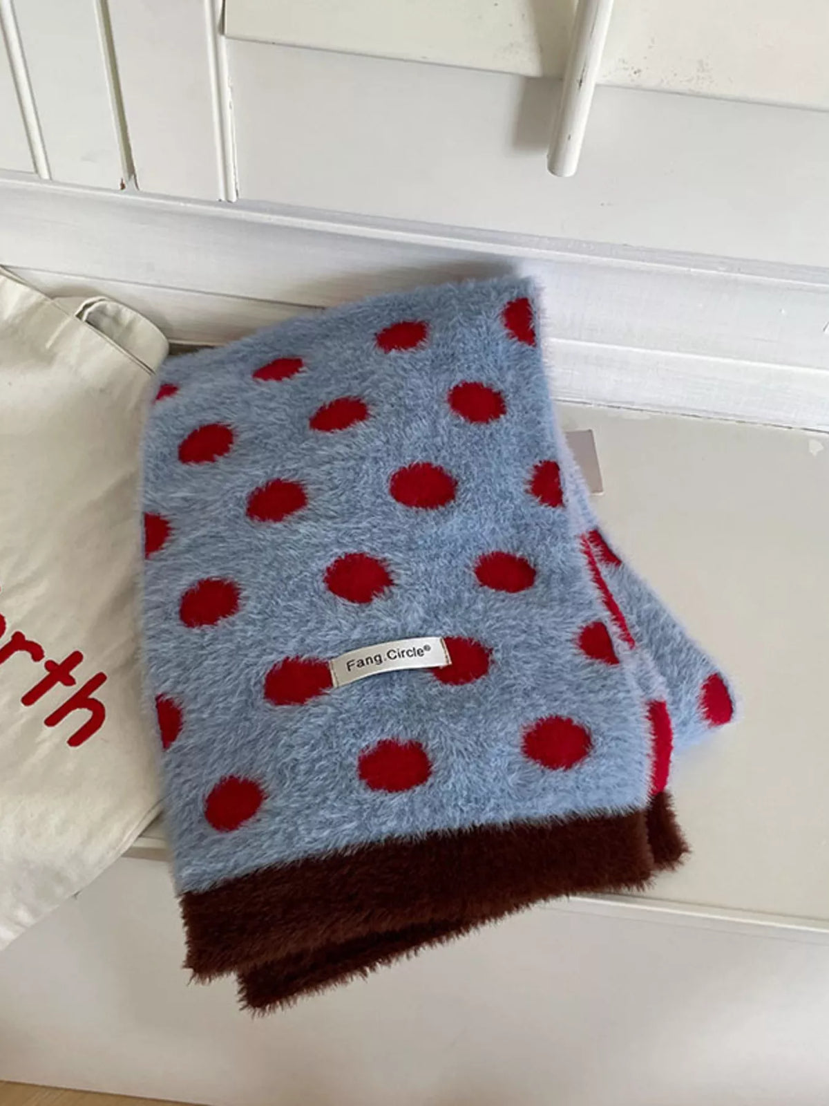 Unisex Blue Polka Dot Scarf — folded blue polka dot scarf with red border visible