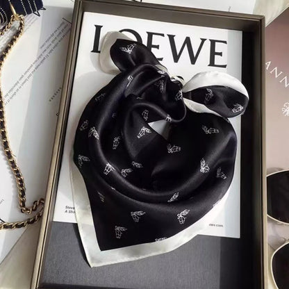 Unisex Printed Lightweight Silk Scarf — black printed scarf gathered in a loose circular shape