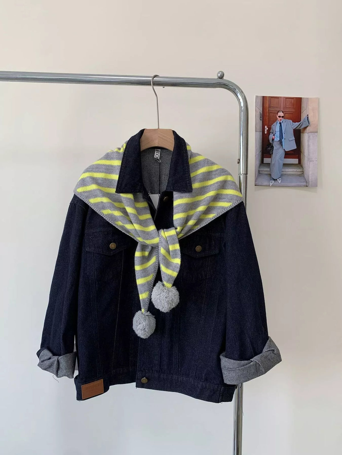 Unisex Striped Knitted Scarf with Pom-Poms — green striped scarf tied close to the jacket neckline