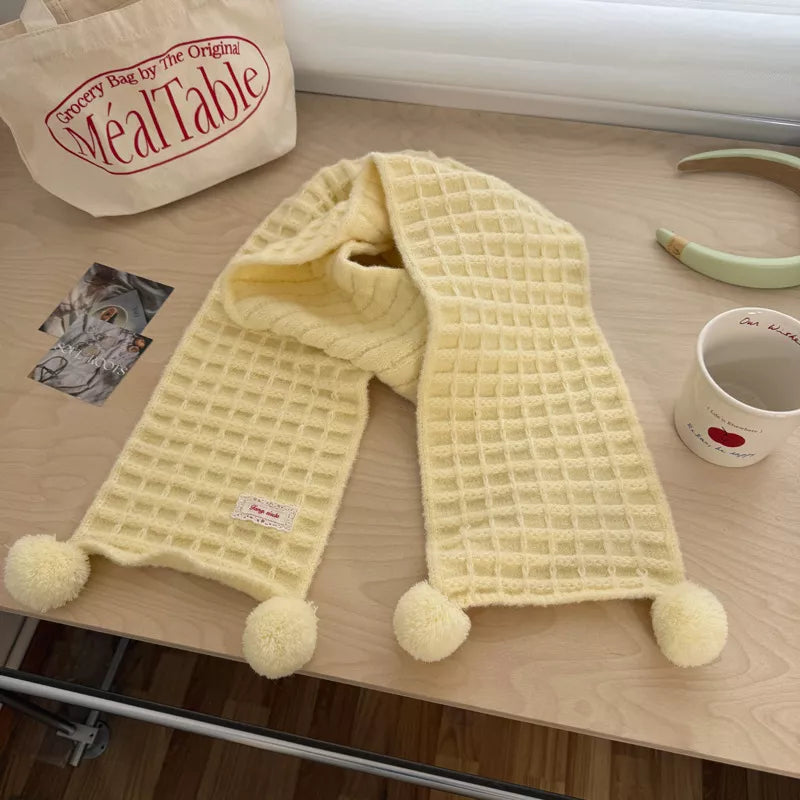 Unisex Waffle Knit Pom-Pom Scarf — creamy yellow scarf draped with pom-pom tips