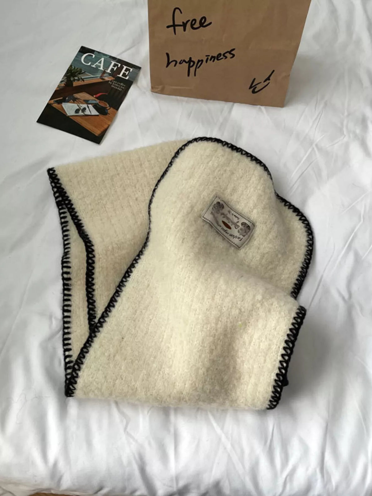 Unisex Contrast Edge Plush Scarf — off-white scarf showing its narrow dark border