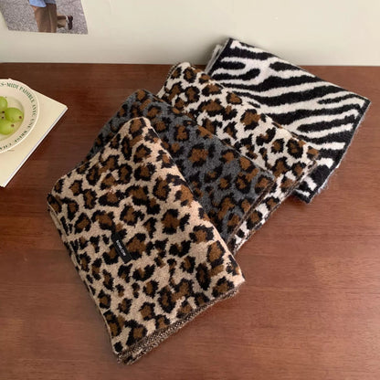 Unisex Animal Print Wool Scarf — leopard patterned scarf folded on a wooden surface