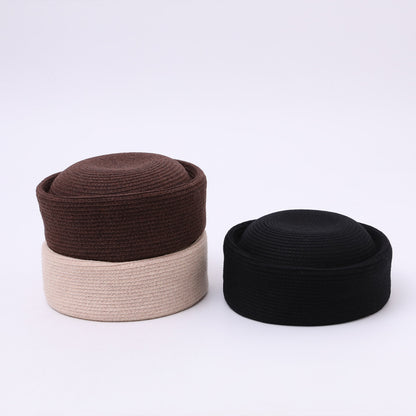 Women's structured pillbox hat shown from the side