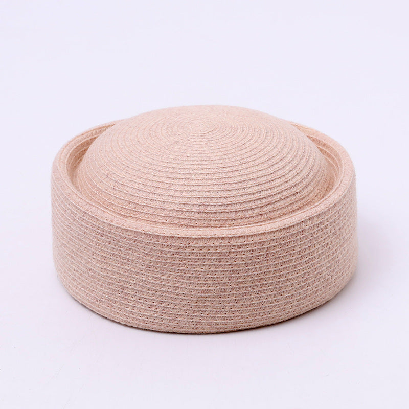 Black women's pillbox hat styled for formal outfits