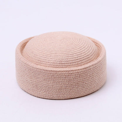 Black women's pillbox hat styled for formal outfits