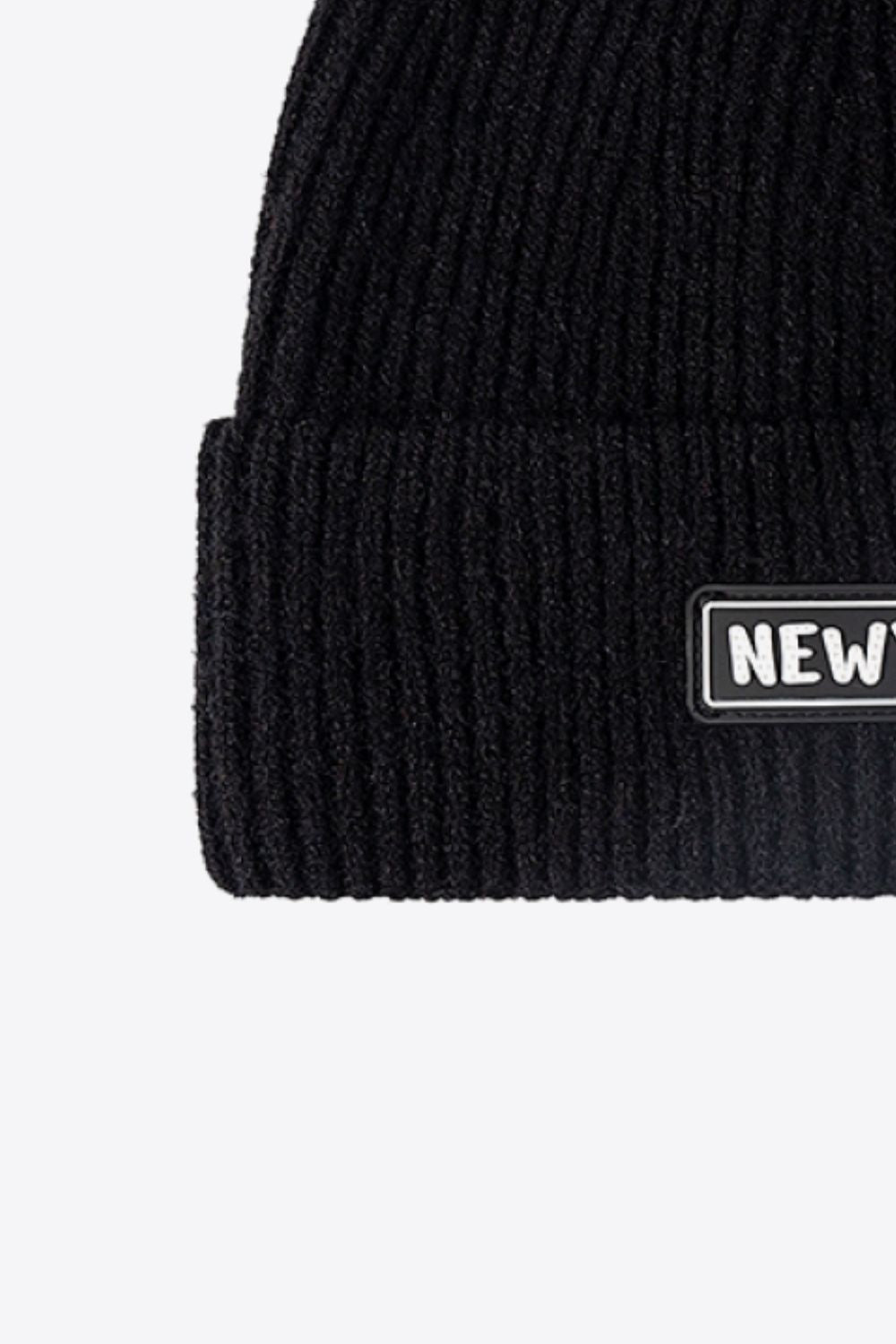 Rust rib-knit cuffed beanie folded brim close-up