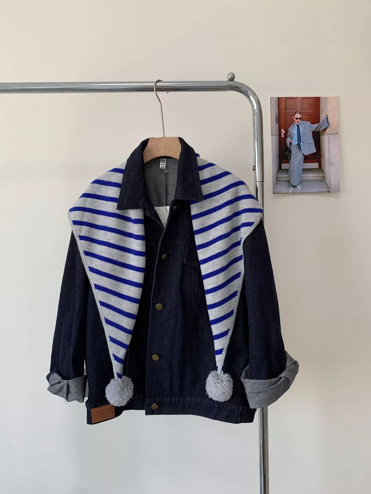 Unisex Striped Knitted Scarf with Pom-Poms — blue and white striped scarf worn open over dark outerwear