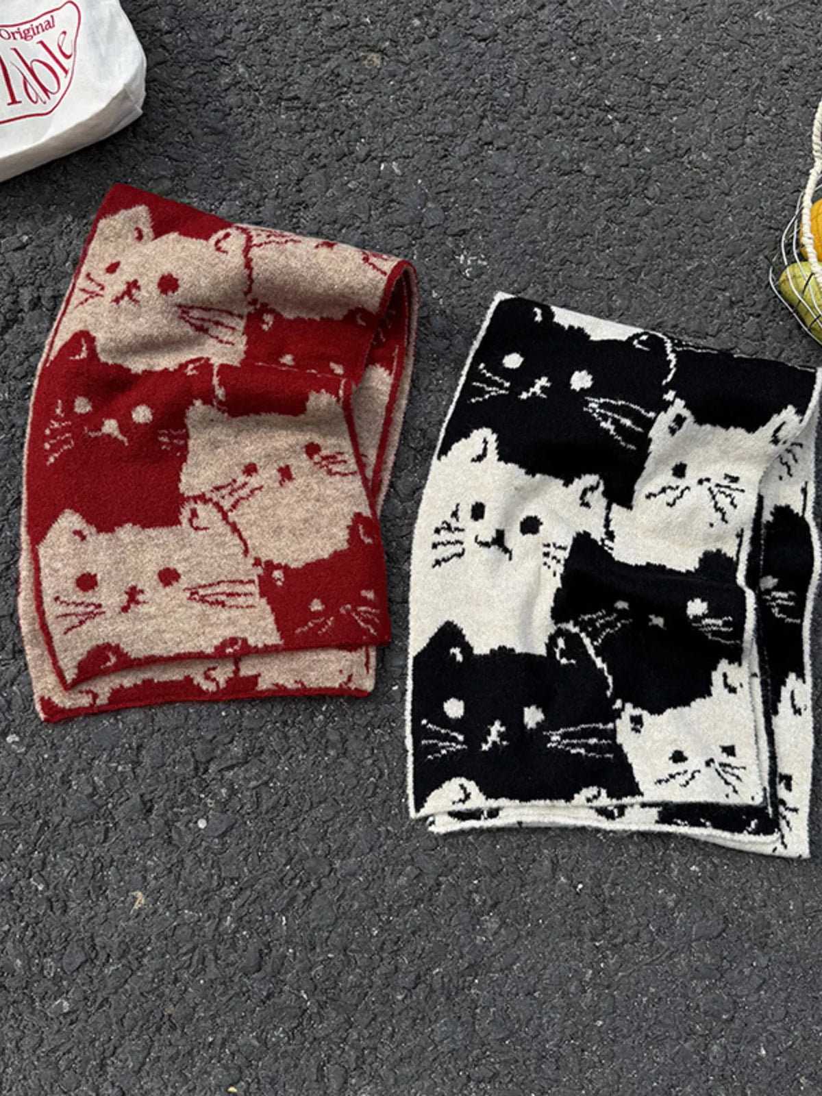 Unisex Allover Cat Knit Scarf — red and black folded scarves showing repeating cat silhouettes