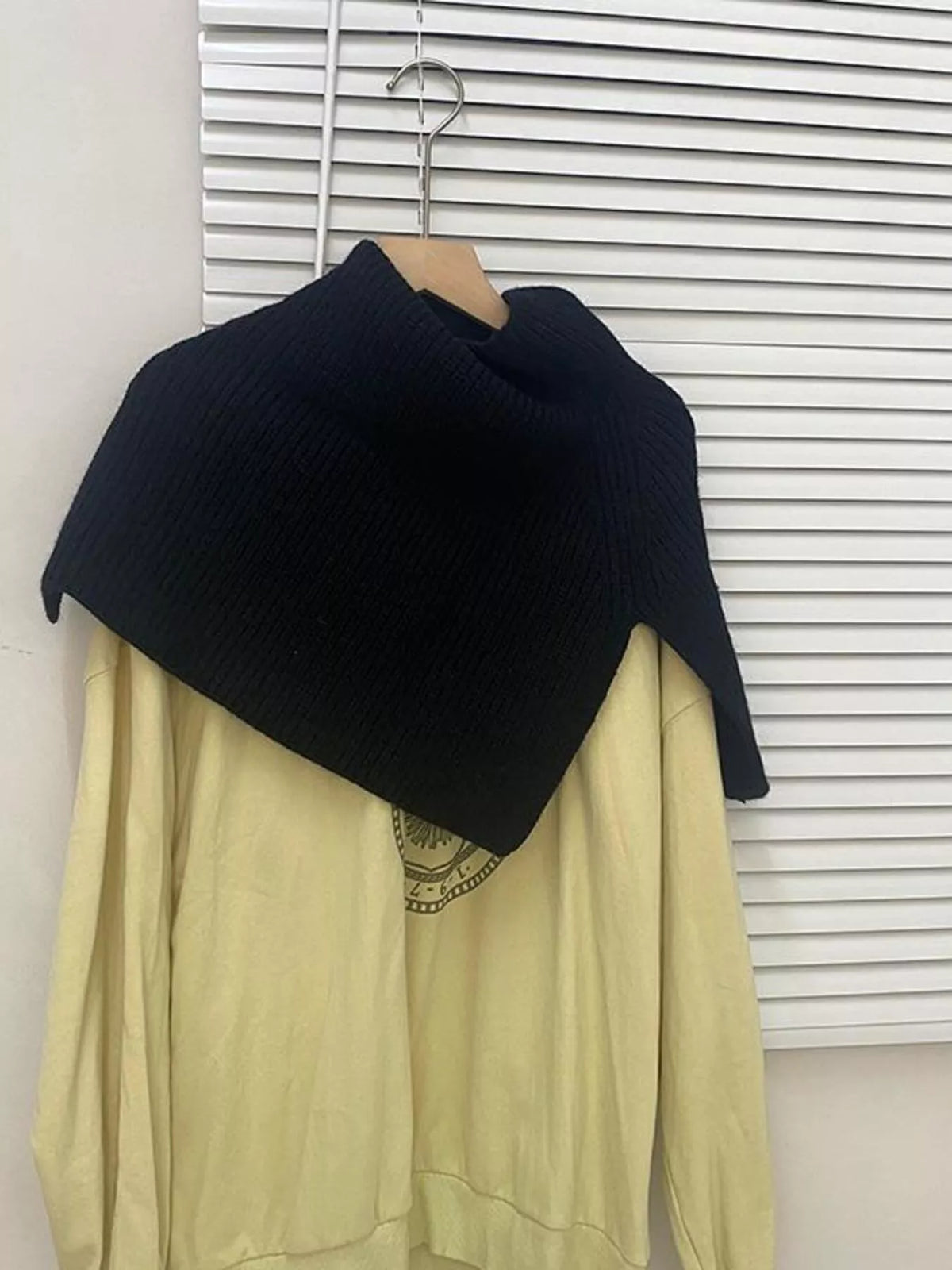 Women's Ribbed Knit Capelet — black knitted shoulder capelet on a hanger