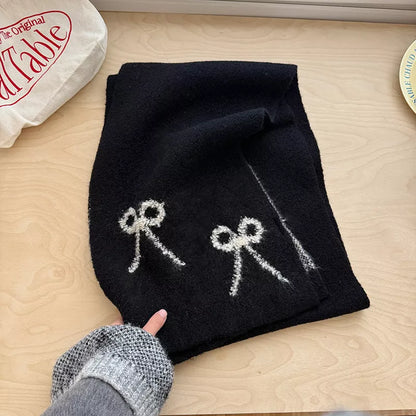 Unisex Bow Detail Knit Scarf — black scarf showing contrasting pale bow motifs