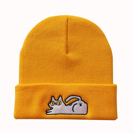 Golden yellow cuffed knit beanie with a small lazy cat motif