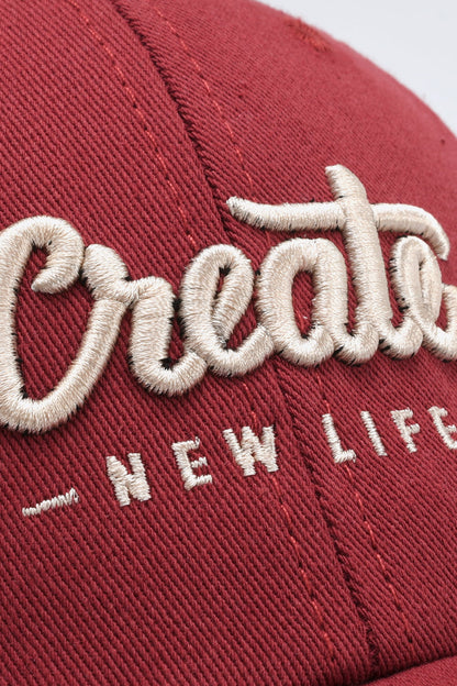 Curved brim CREATE NEW LIFE cap side angle