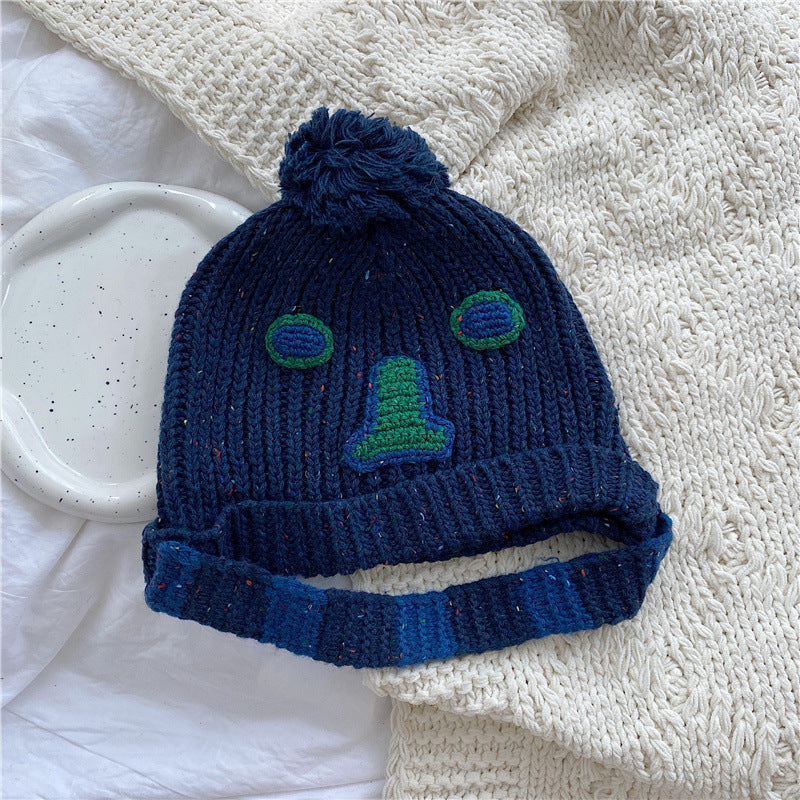 Unisex Cartoon Embroidered Pom Pom Knit Beanie — blue pom-pom beanie showing contrasting cuff stripes