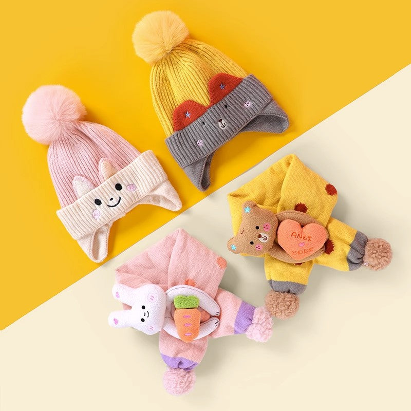 Three colorful animal beanie and scarf sets shown in a flat lay
