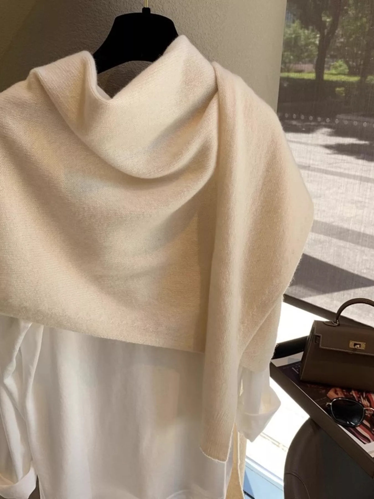 Women's Wool Knitted Asymmetrical Shawl — side view of asymmetrical cream shawl