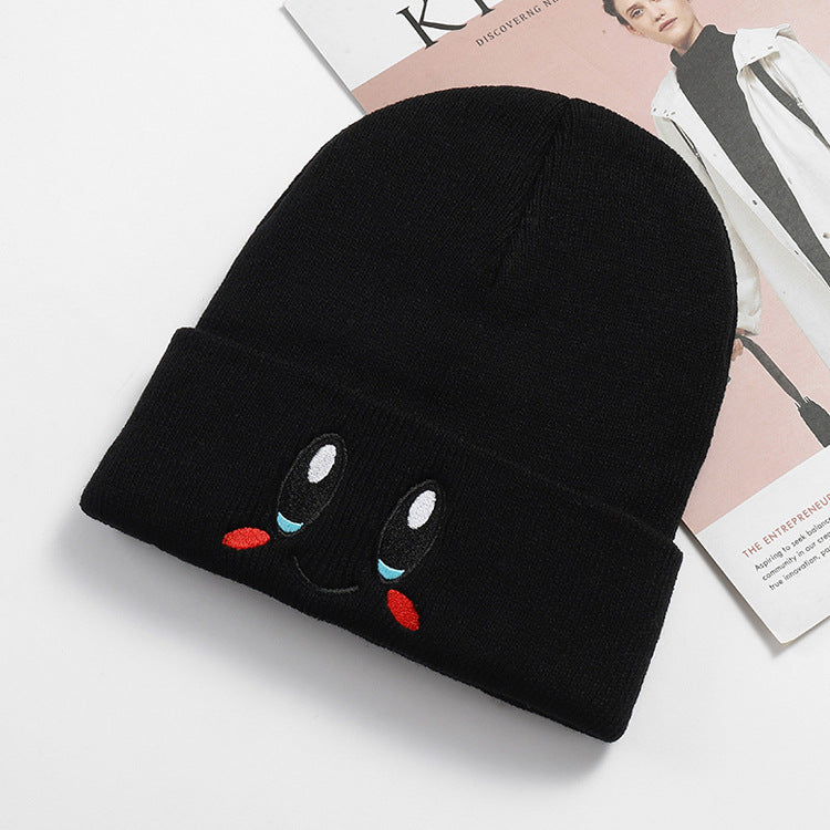 Black smile face knit beanie with a folded cuff