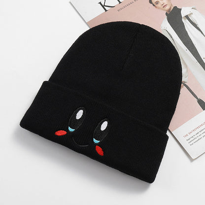 Black smile face knit beanie with a folded cuff