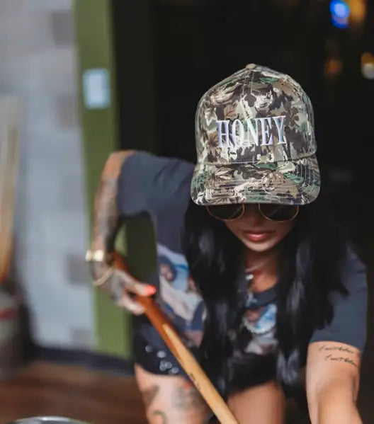 The Mad Hatter Company Honey Snapback, leaf camouflage Honey cap worn outdoors