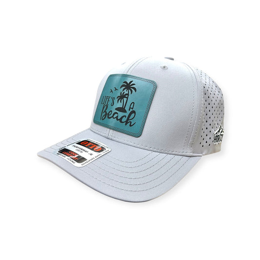 Angled view of Life's A Beach patch hat by Horizon Hat Co. in white showing the bill and side panels