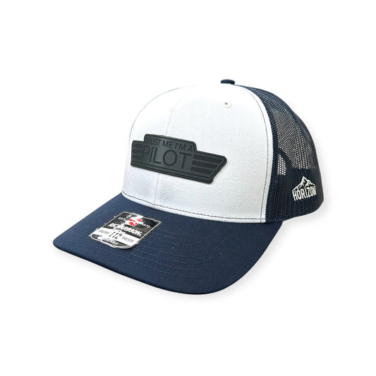 Angled view of Trust Me, I'm a Pilot patch hat by Horizon Hat Co. in white/navy showing the curved bill and side panels