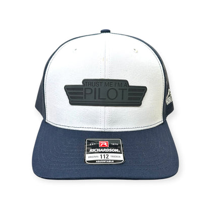 Front view of Trust Me, I'm a Pilot patch hat by Horizon Hat Co. in white/navy showing aviation-humor pilot patch