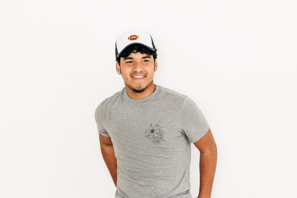 Rey To Z person wearing the Navy/White football-patch trucker